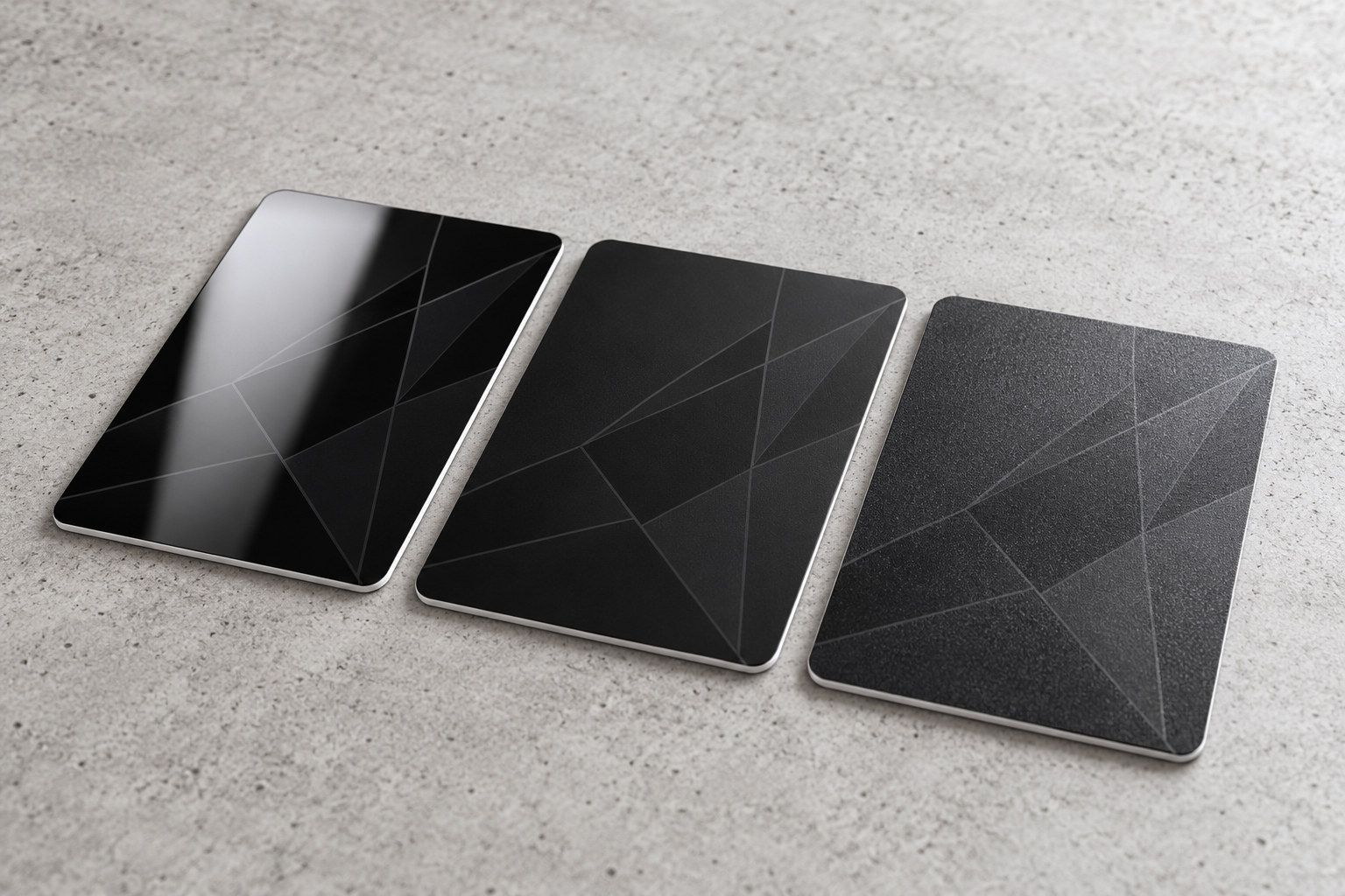 Three black cards side by side: glossy black with a reflection band, velvety matte black, grainy frosted black