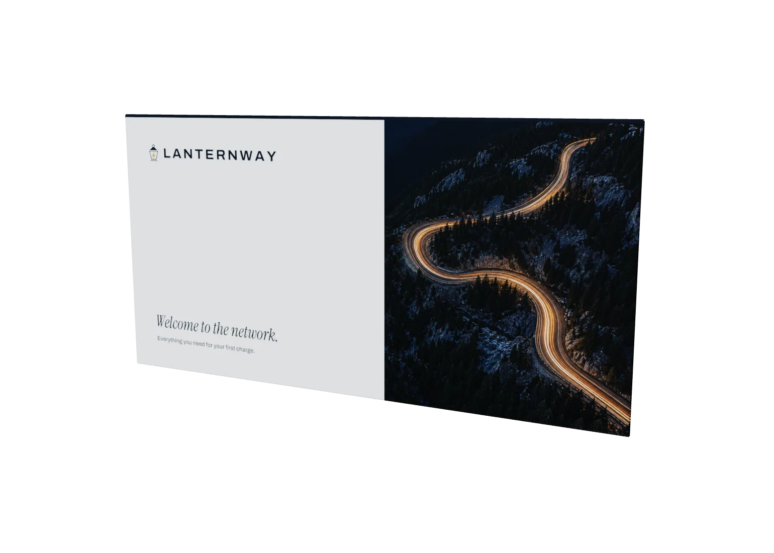 White DL envelope with a Lanternway lantern logo and an aerial night photo of a winding road lit amber